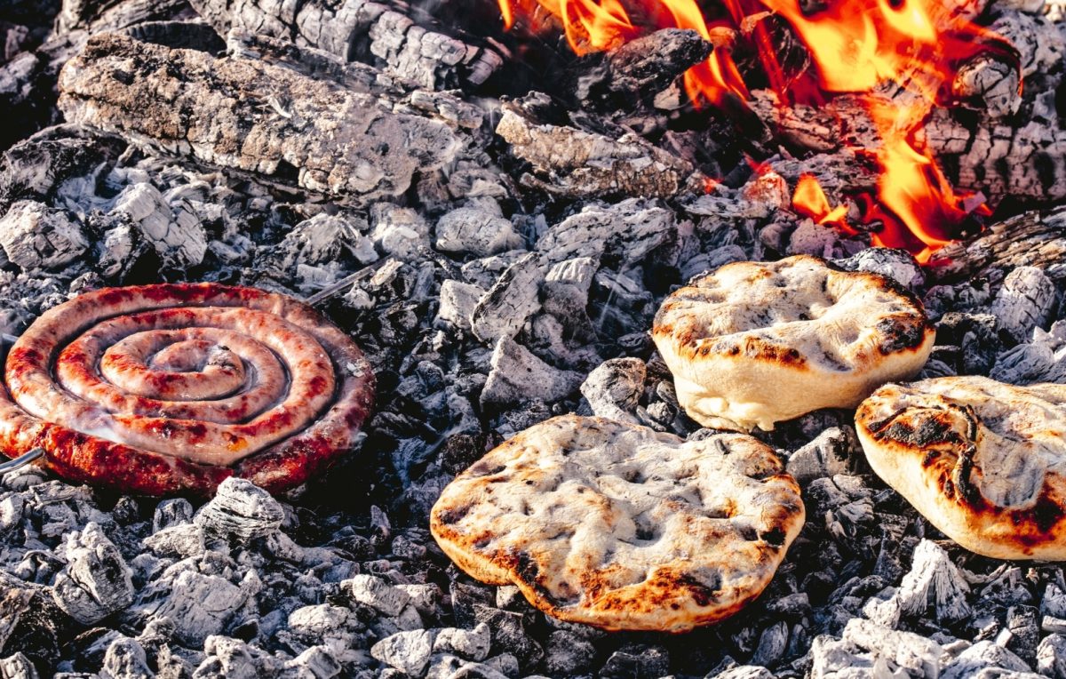 Boerewors and askoek cooked directly on hot coals