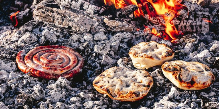 Boerewors and askoek cooked directly on hot coals